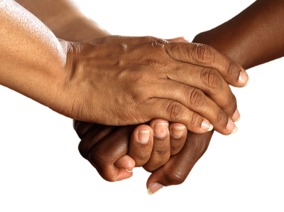 Image of three hands being held together. The hands are of mutiple racial identities.